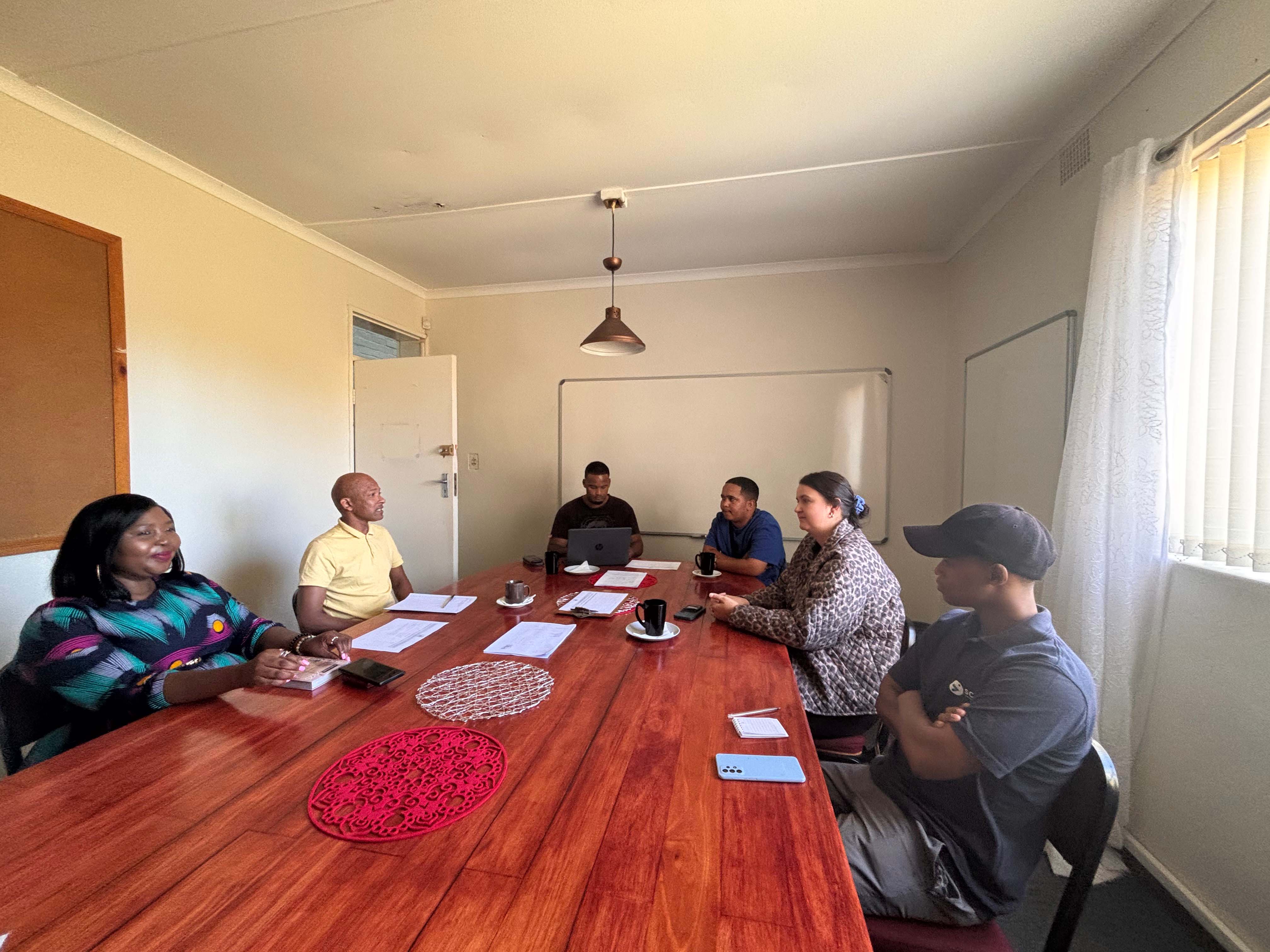 Hlonie Mercy Mgijima (General Manager) and Rowan Garnad from Elgin Community College (left) chatting to some programme beneficiaries as they prepare to begin their studies